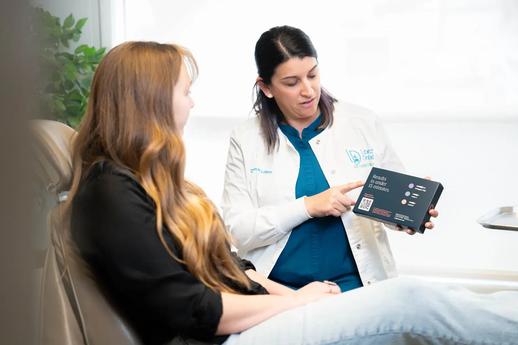 Dental professional reviewing Oral Genome chairside testing with a patient