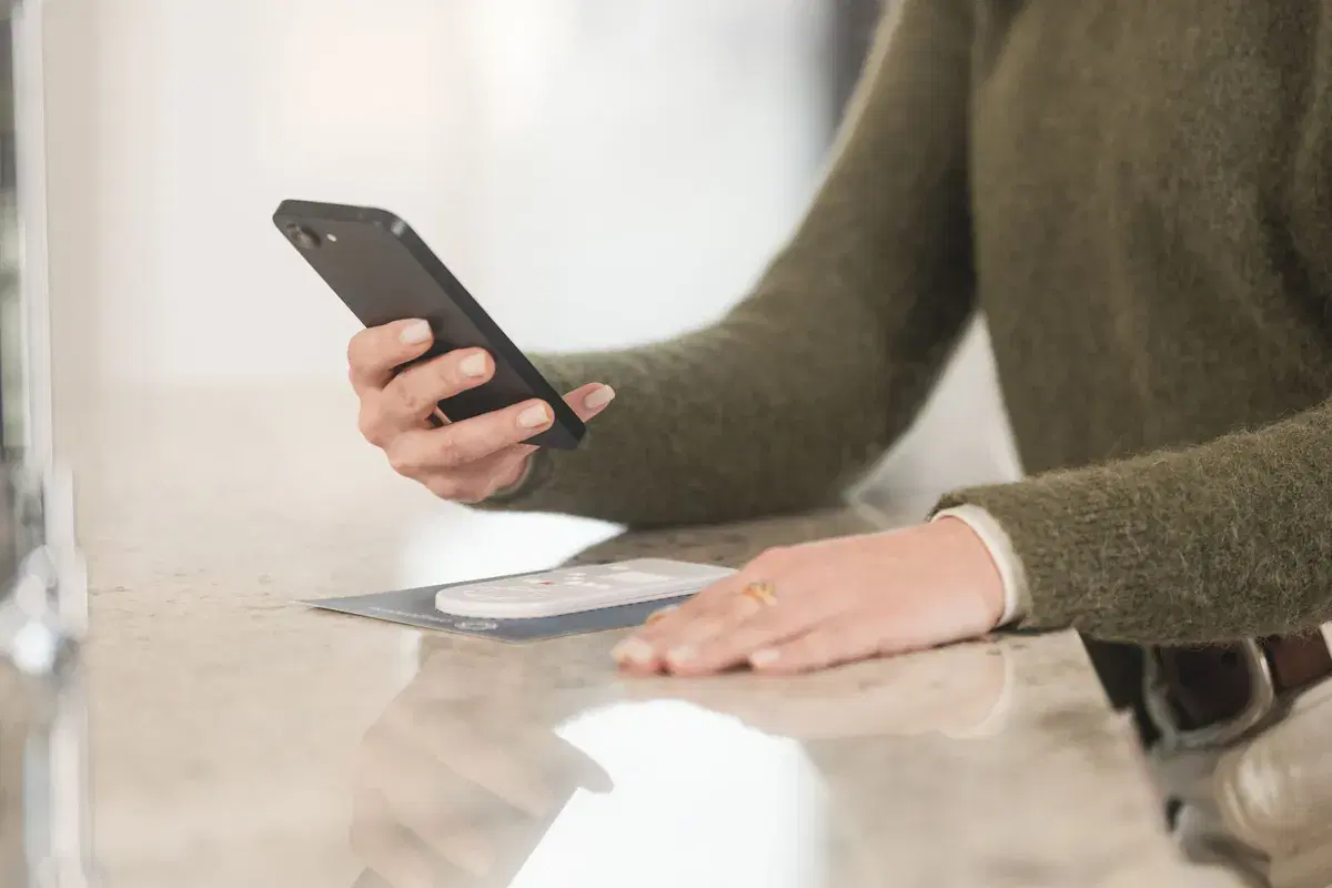 Hands capturing an Oral Genome test with a smartphone